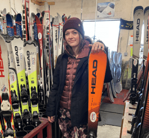 A girl holding an orange ski (300x278)