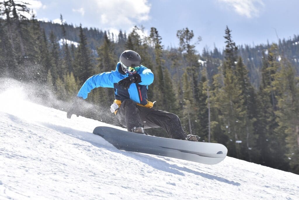 A person is snowboarding down the mountain