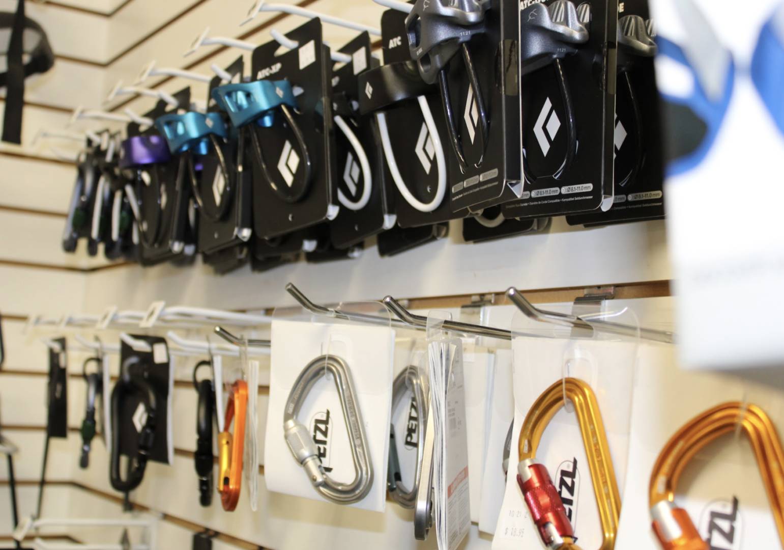 A wall of different types of cords hanging on hooks.