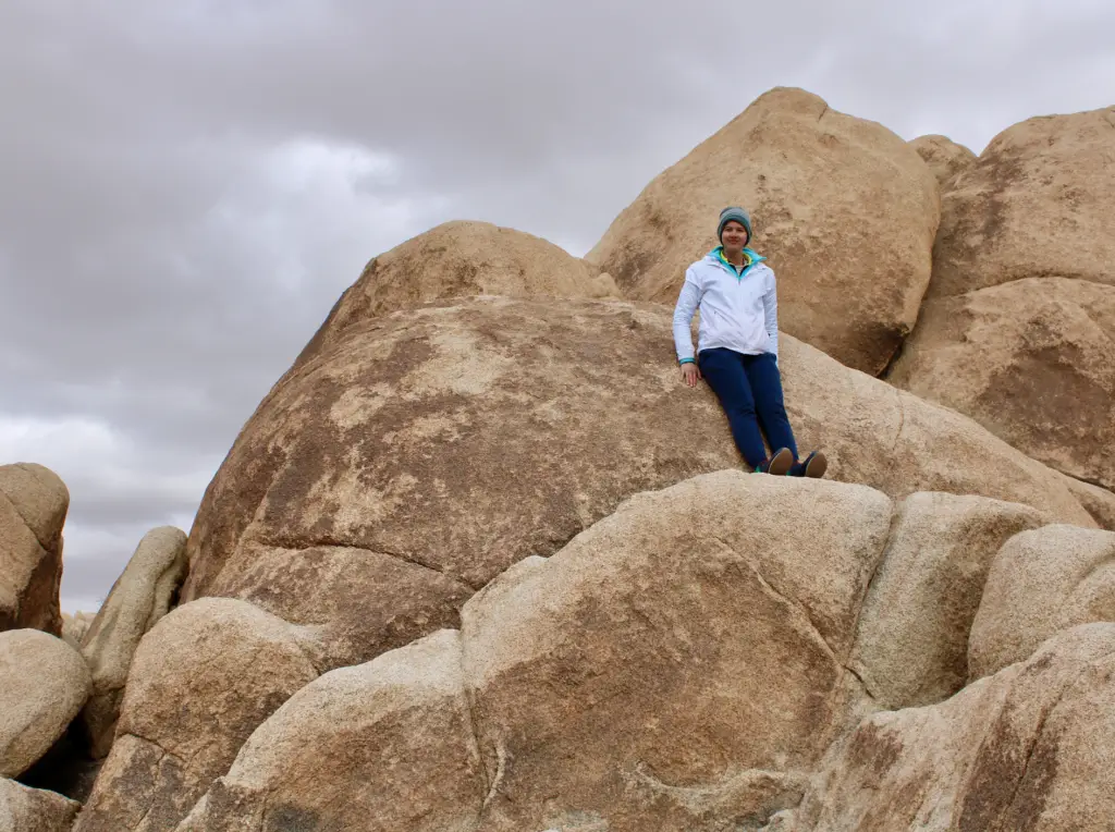 A person standing on top of a rock formation.