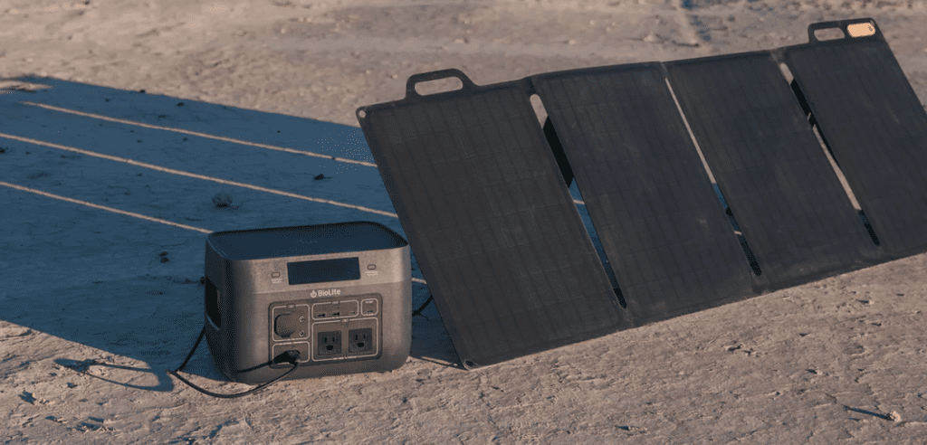 A solar panel and charger on the ground.