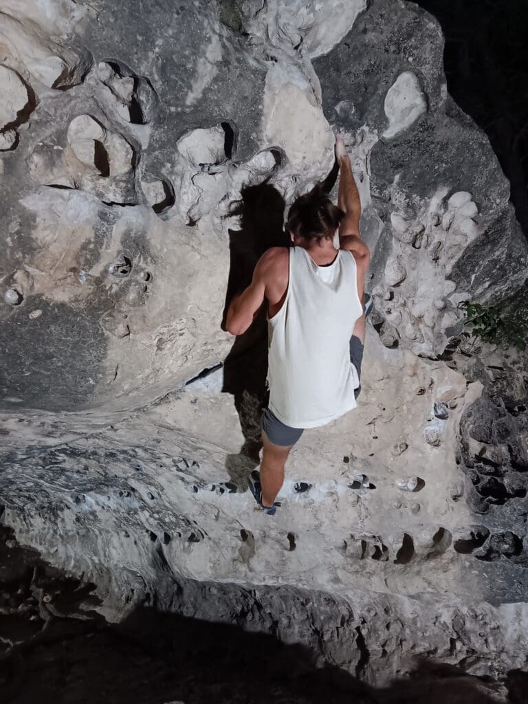 A man standing on top of a rock formation.