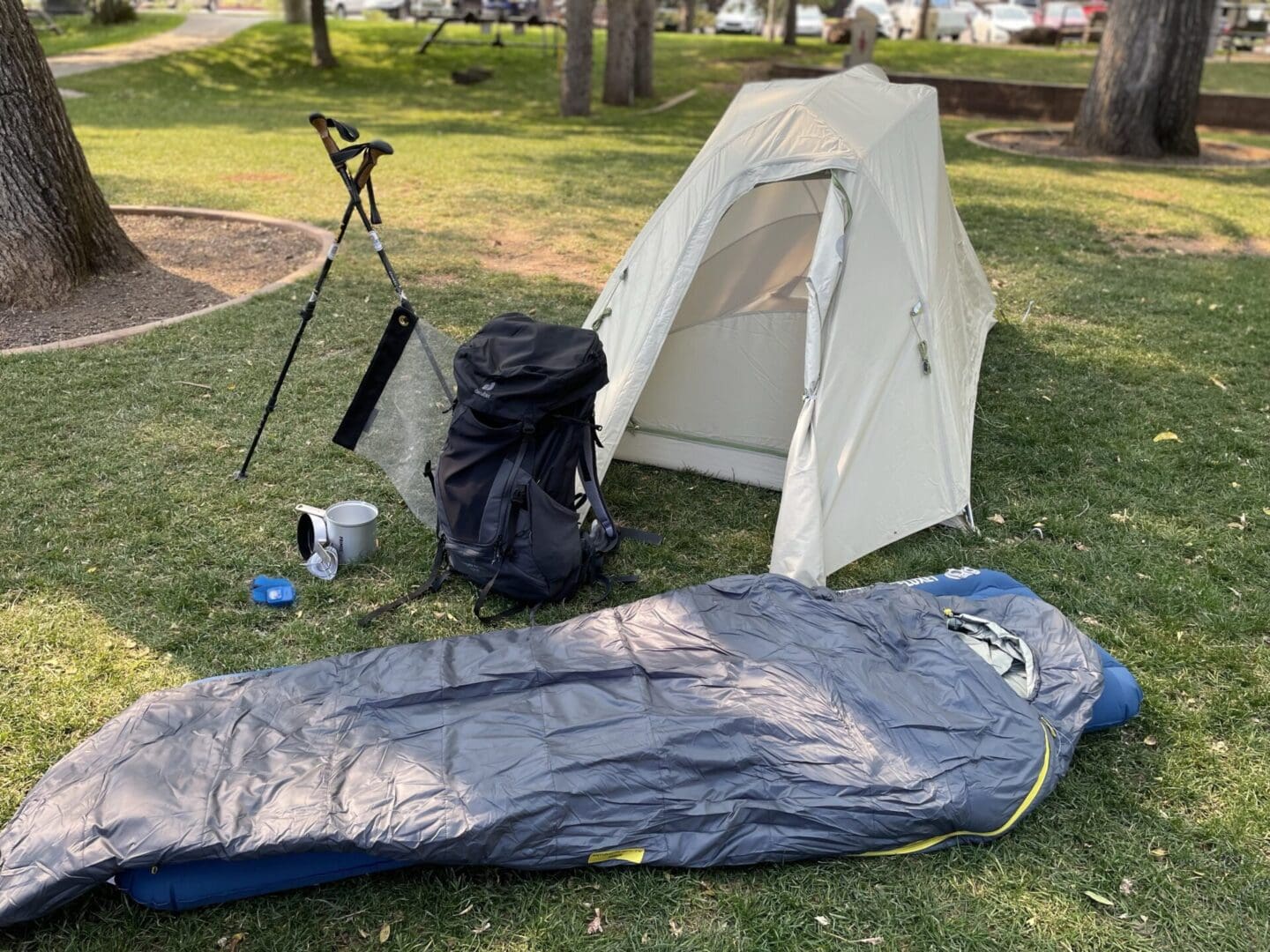 Camping gear laid out on grass.