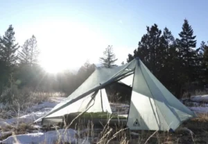 Lightweight backpacking tent in snowy woods.